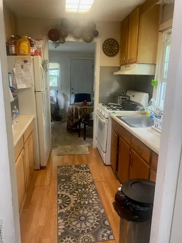 a kitchen with refrigerator a stove a washer and dryer