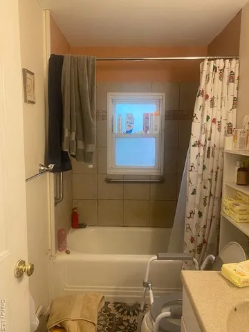 a bathroom with a bathtub and shower