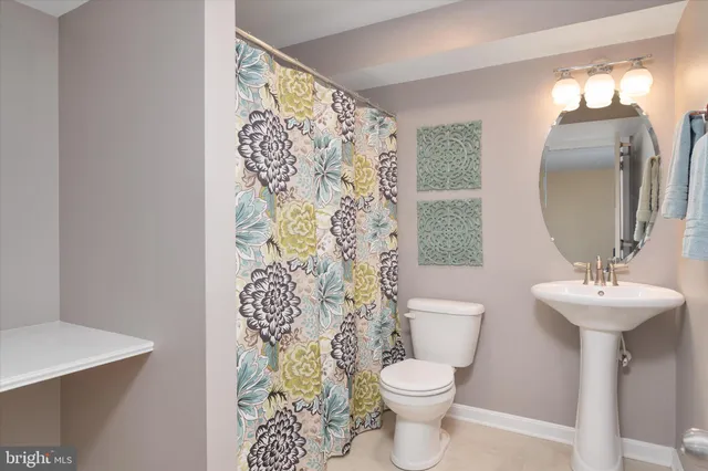 a view of a patio with table and chairs potted plants and a large tree