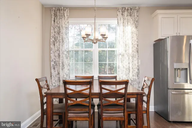 a kitchen with kitchen island granite countertop stainless steel appliances and wooden cabinets