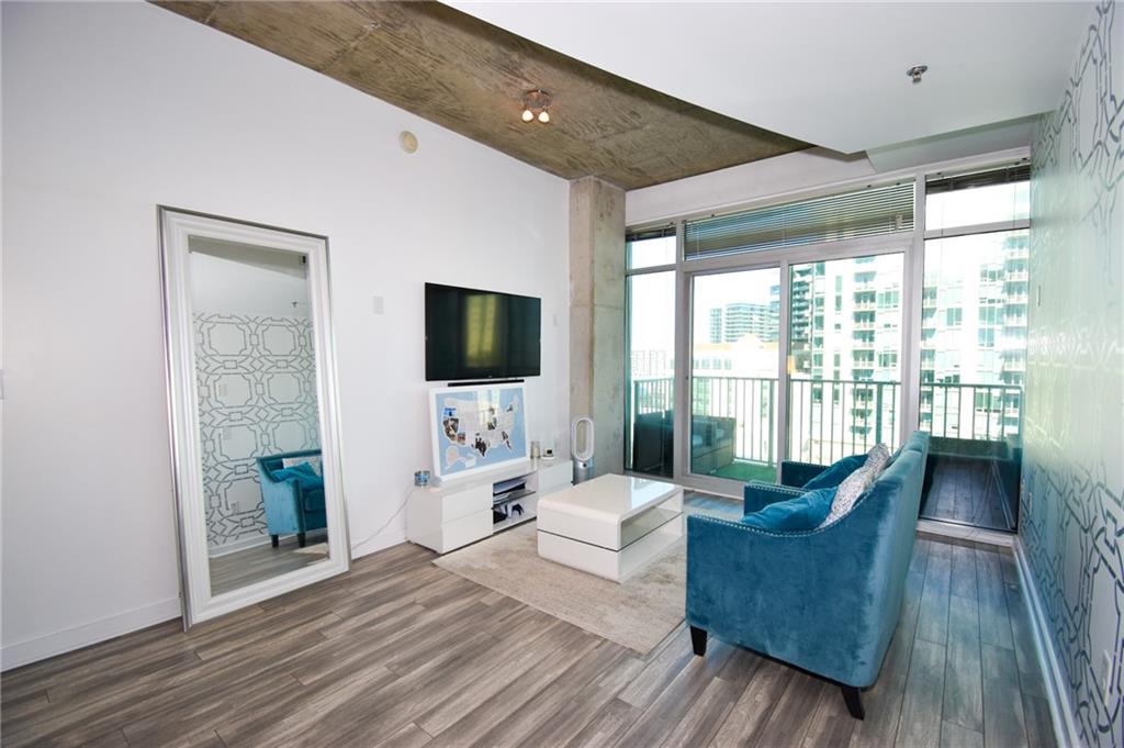 250 Pharr Road Northeast, Unit 1103 Atlanta, GA 30305 - Photo 3 of 16 a living room with furniture and a flat screen tv