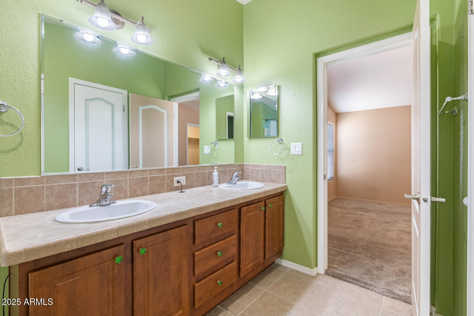 1706 East John Cabot Road Phoenix, AZ 85022 - Photo 16 of 26 a bathroom with a double vanity sink and a mirror