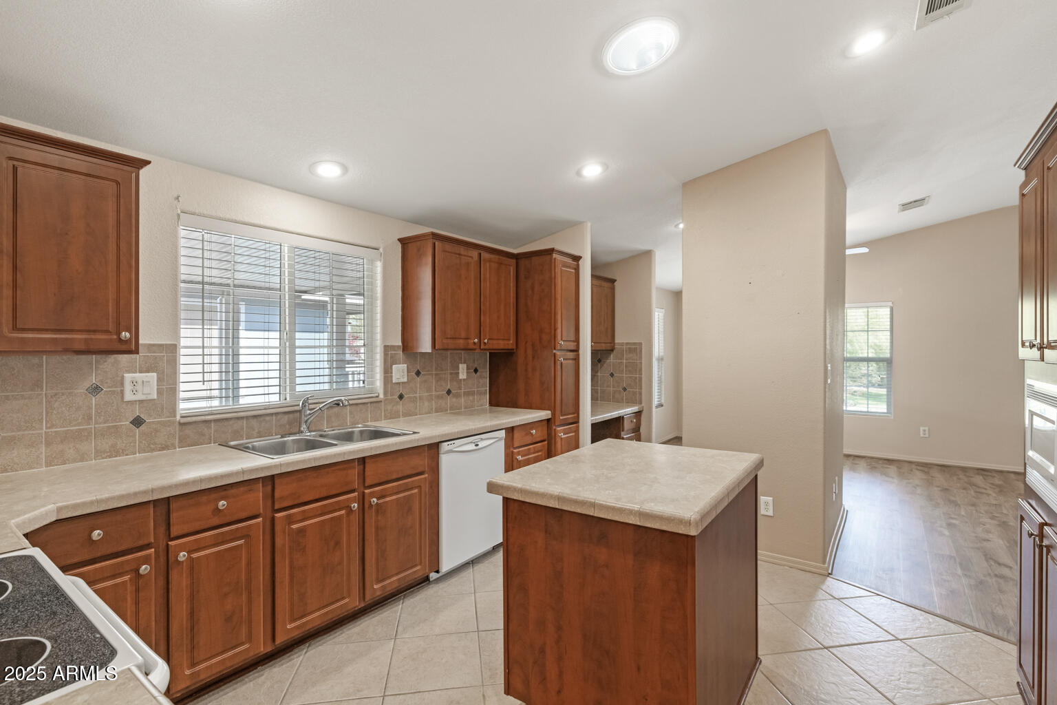 1706 East John Cabot Road Phoenix, AZ 85022 - Photo 9 of 26 a kitchen with a sink stove and cabinets