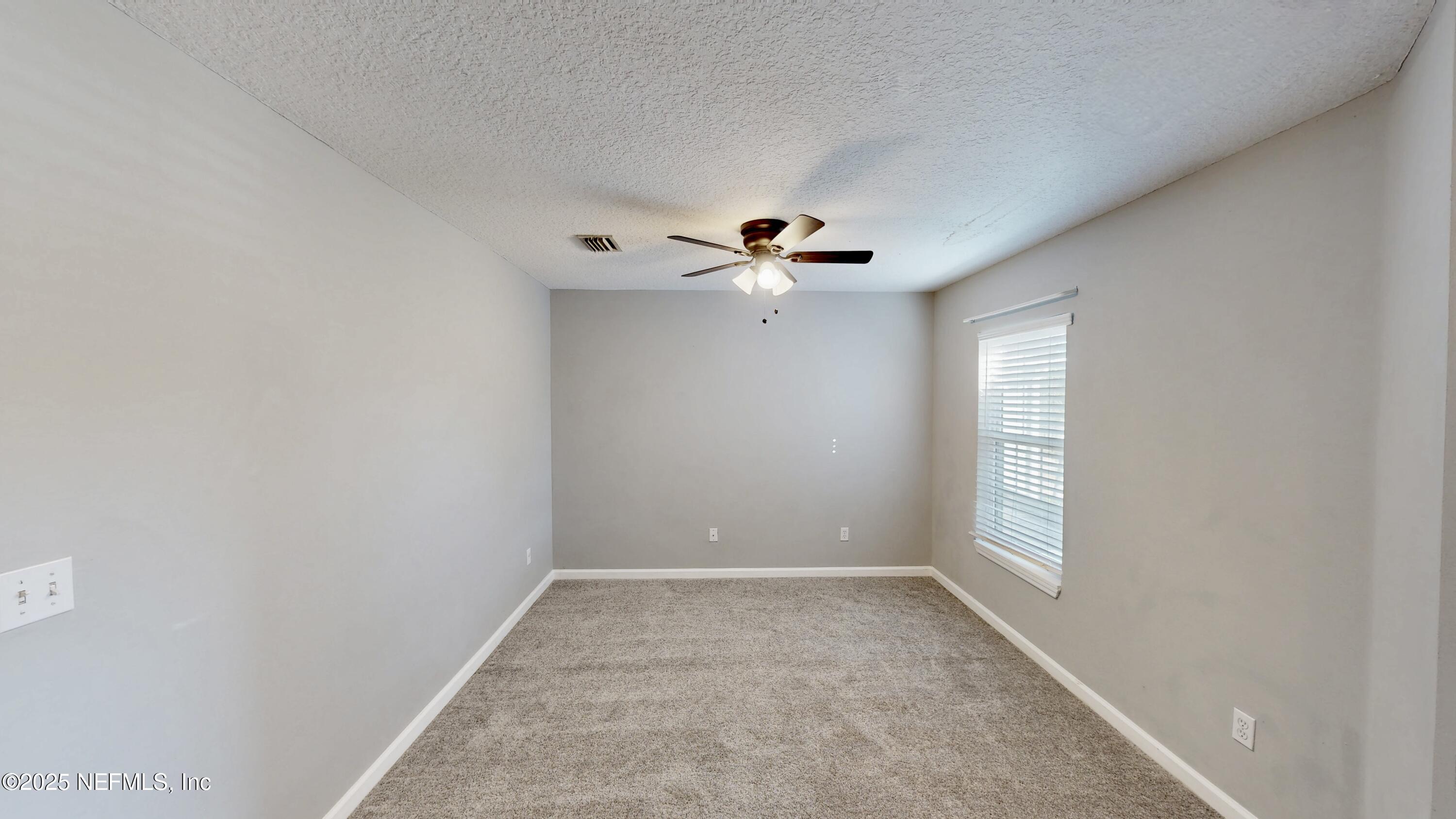 1445 Biscayne Bay Drive Jacksonville, FL 32218 - Photo 5 of 10 a view of an empty room with a window