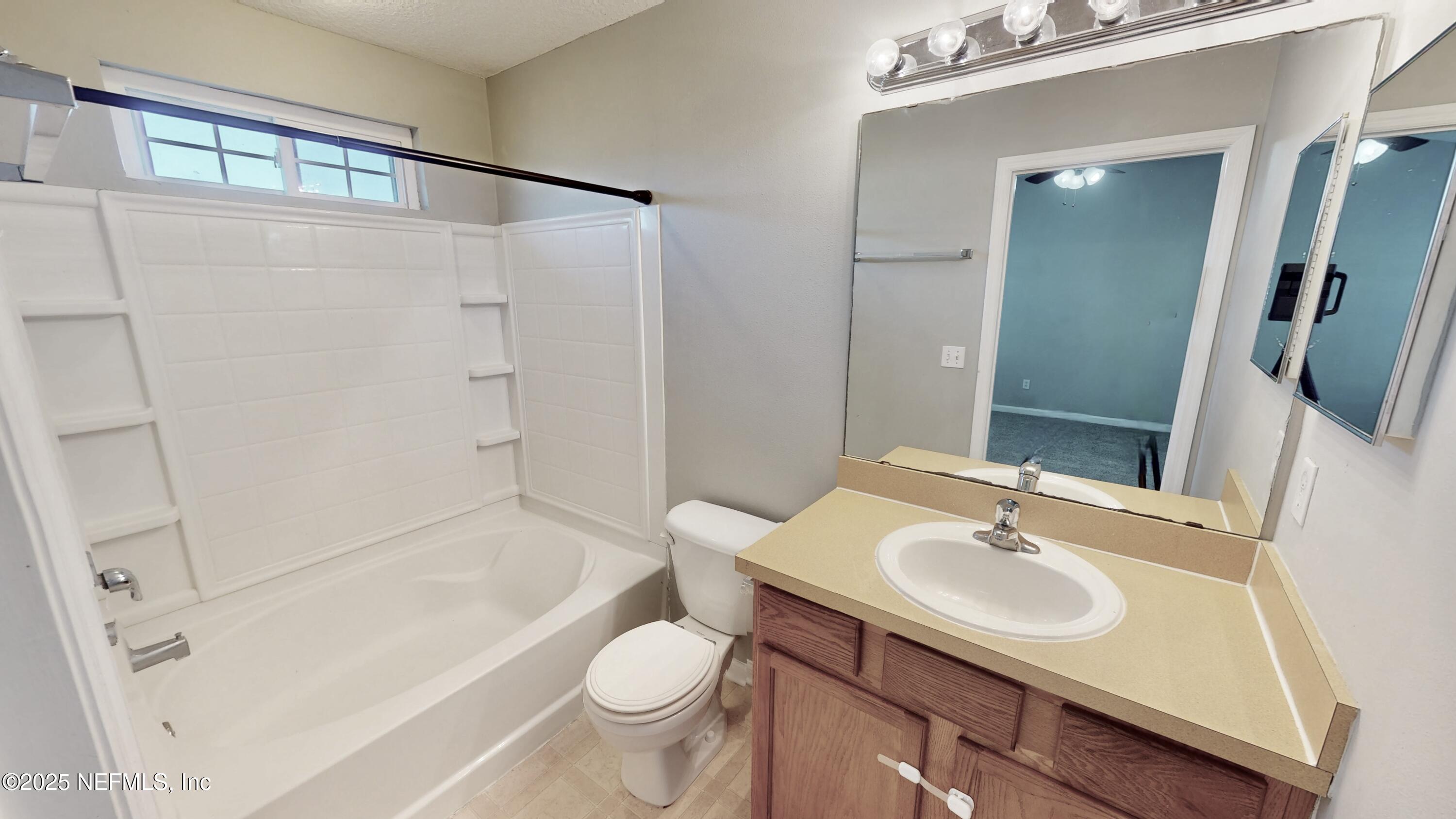 1445 Biscayne Bay Drive Jacksonville, FL 32218 - Photo 10 of 10 a bathroom with a sink toilet and shower