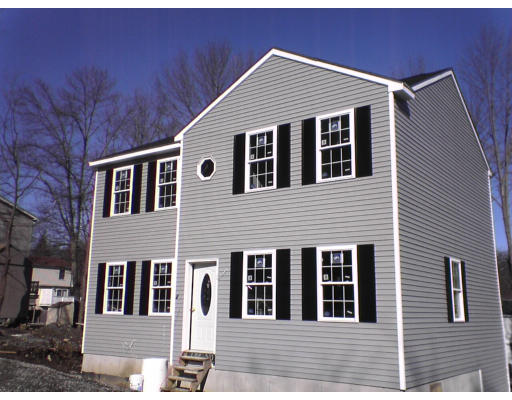24 El Caney Road Worcester, MA 01603 - Photo 1 of 1 a front view of a house with large windows