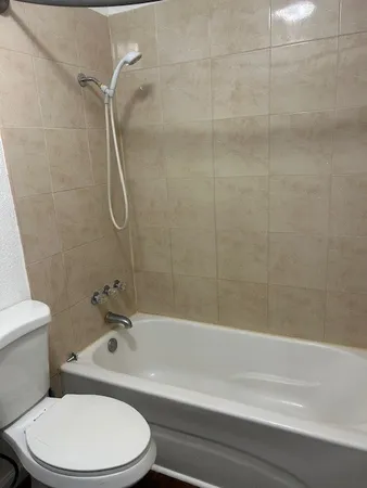 a white toilet sitting next to a sink
