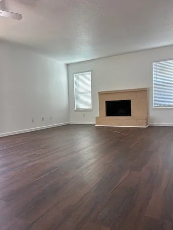 a view of a room with wooden floor water heater and kitchen view