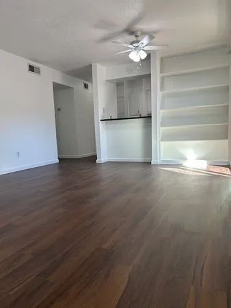 a kitchen with stainless steel appliances a refrigerator sink and wooden floor
