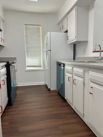 a kitchen with white cabinets and a sink