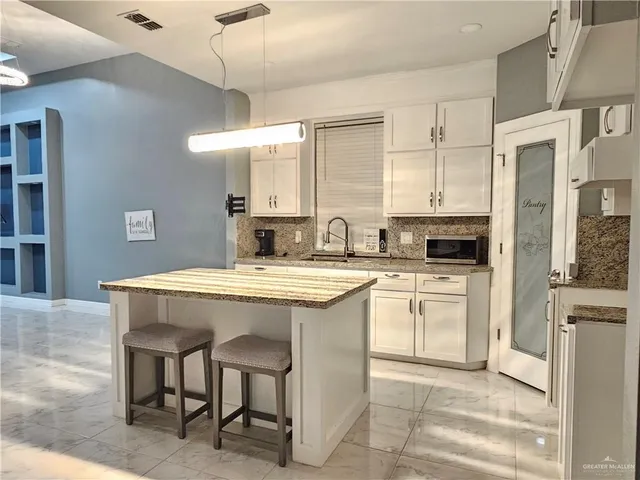 a kitchen with cabinets and sink