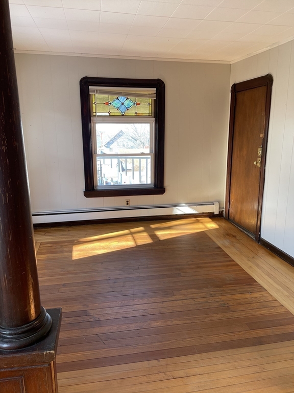 229 Rock Street, Unit 5 Fall River, MA 02720 - Photo 5 of 10 a view of an empty room with wooden floor and a window