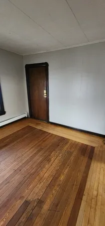 a view of an empty room and wooden floor