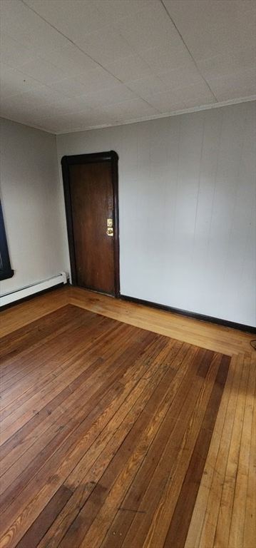 229 Rock Street, Unit 5 Fall River, MA 02720 - Photo 6 of 10 a view of an empty room and wooden floor