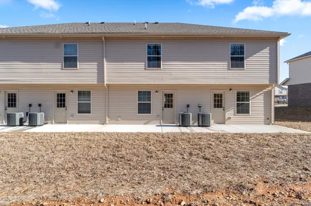 a front view of a house with a yard and covered with snow