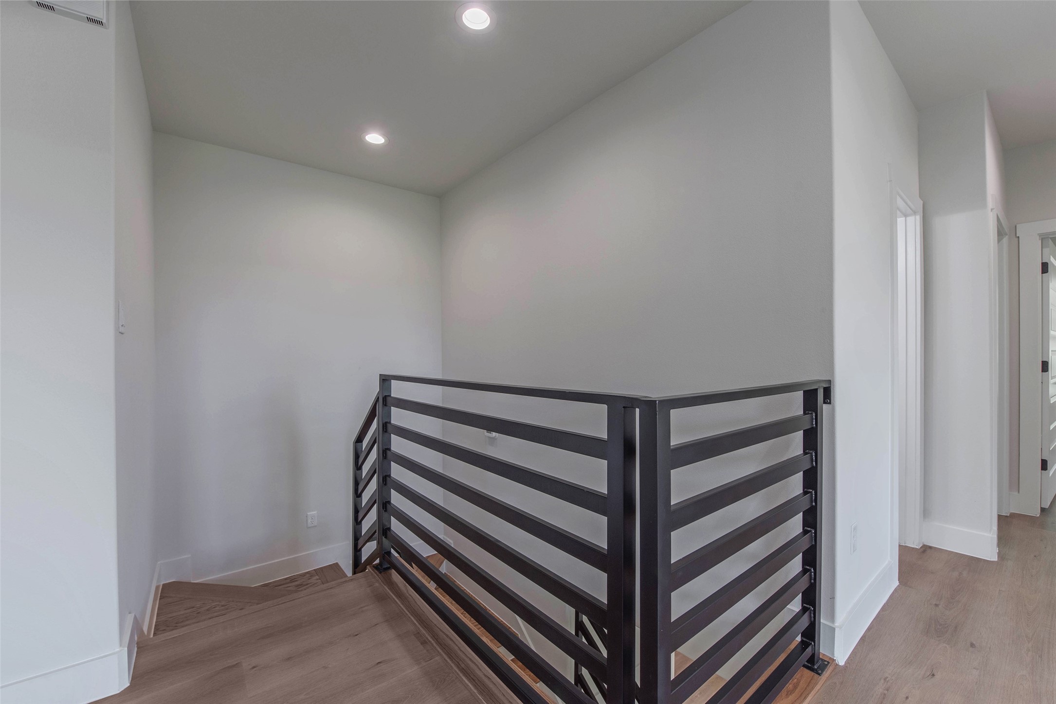 9311 Jutland Road Houston, TX 77033 - Photo 18 of 28 The staircase has a light, airy design that enhances the home’s modern flow and openness.