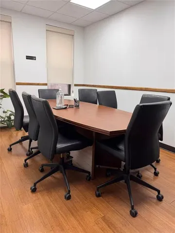 a view of a workspace with furniture and wooden floor