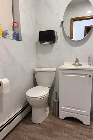 a bathroom with a toilet a sink and a mirror