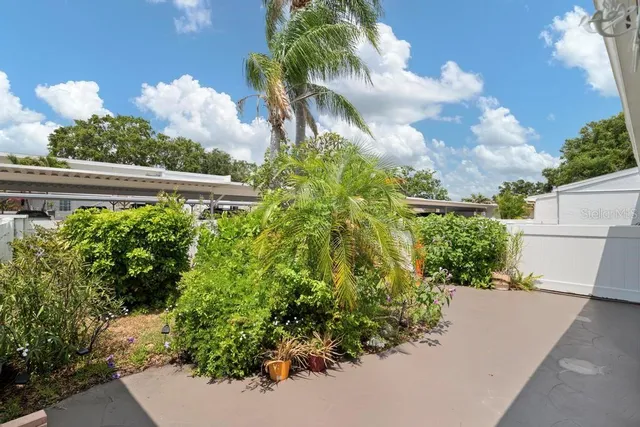 a front view of a house with plants