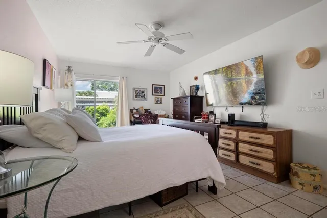 a bedroom with a bed and dresser with mirror