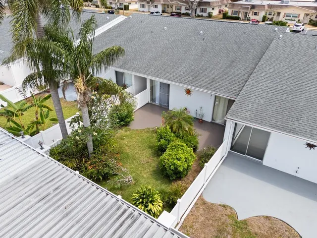 an aerial view of a house with a yard and sitting area