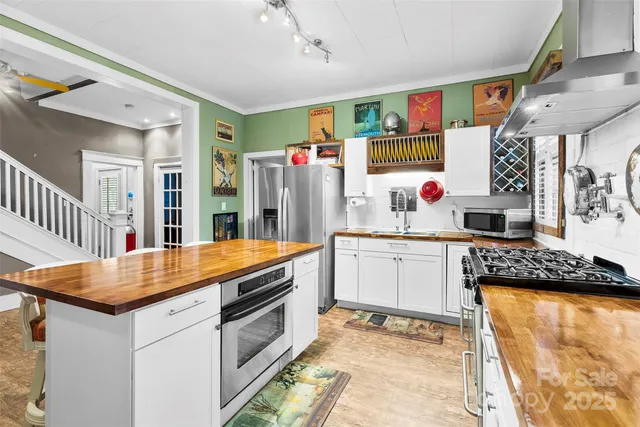 a kitchen with stainless steel appliances granite countertop a stove and a sink