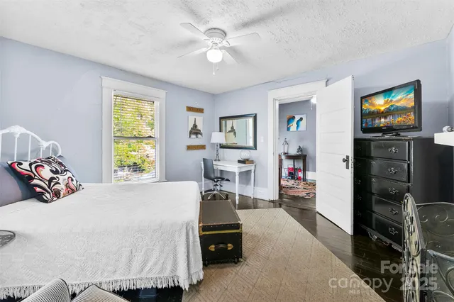 a bedroom with a bed and a tv