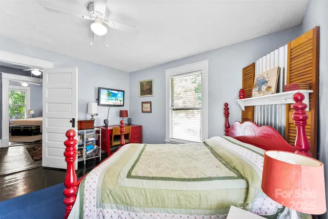 a bedroom with a bed and a bookshelf with wooden floor