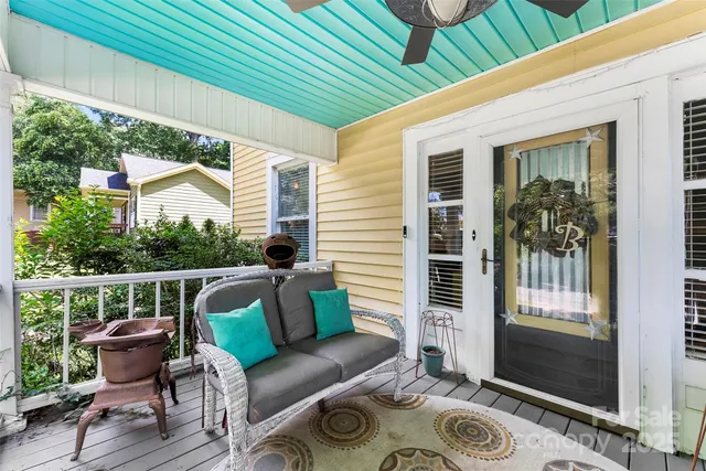 a balcony with furniture and a potted plant