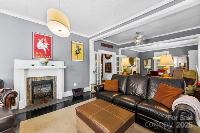 a living room with furniture kitchen view and a fireplace