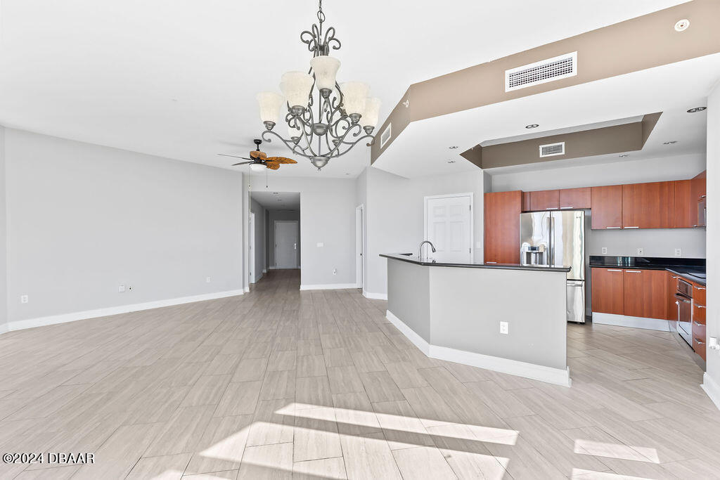 241 Riverside Drive, Unit 2610 Daytona Beach, FL 32117 - Photo 5 of 31 a view of a living room and chandelier