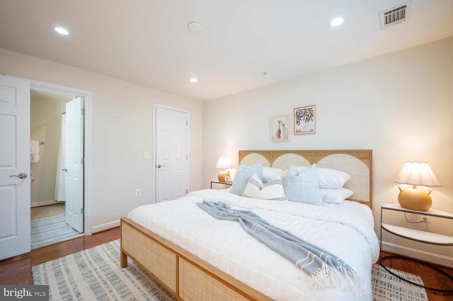 4113 South Four Mile Run Drive, Unit 404 Arlington, VA 22204 - Photo 12 of 39 a bedroom with a bed and wooden floor