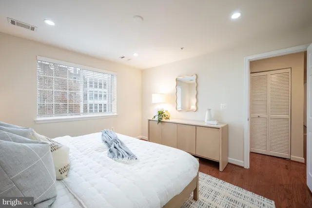 a bed room with a bed and a window