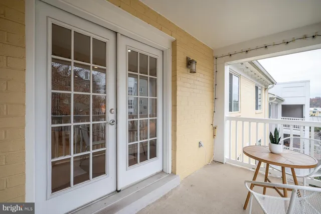 a view of a bedroom with furniture and window