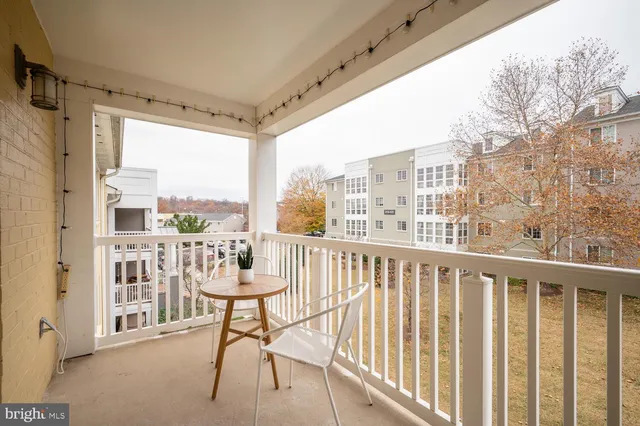a view of a balcony with furniture and a floor to ceiling window