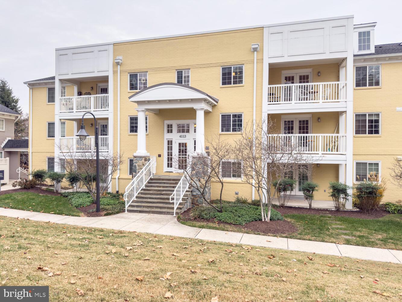 4113 South Four Mile Run Drive, Unit 404 Arlington, VA 22204 - Photo 27 of 39 a front view of a house with a yard