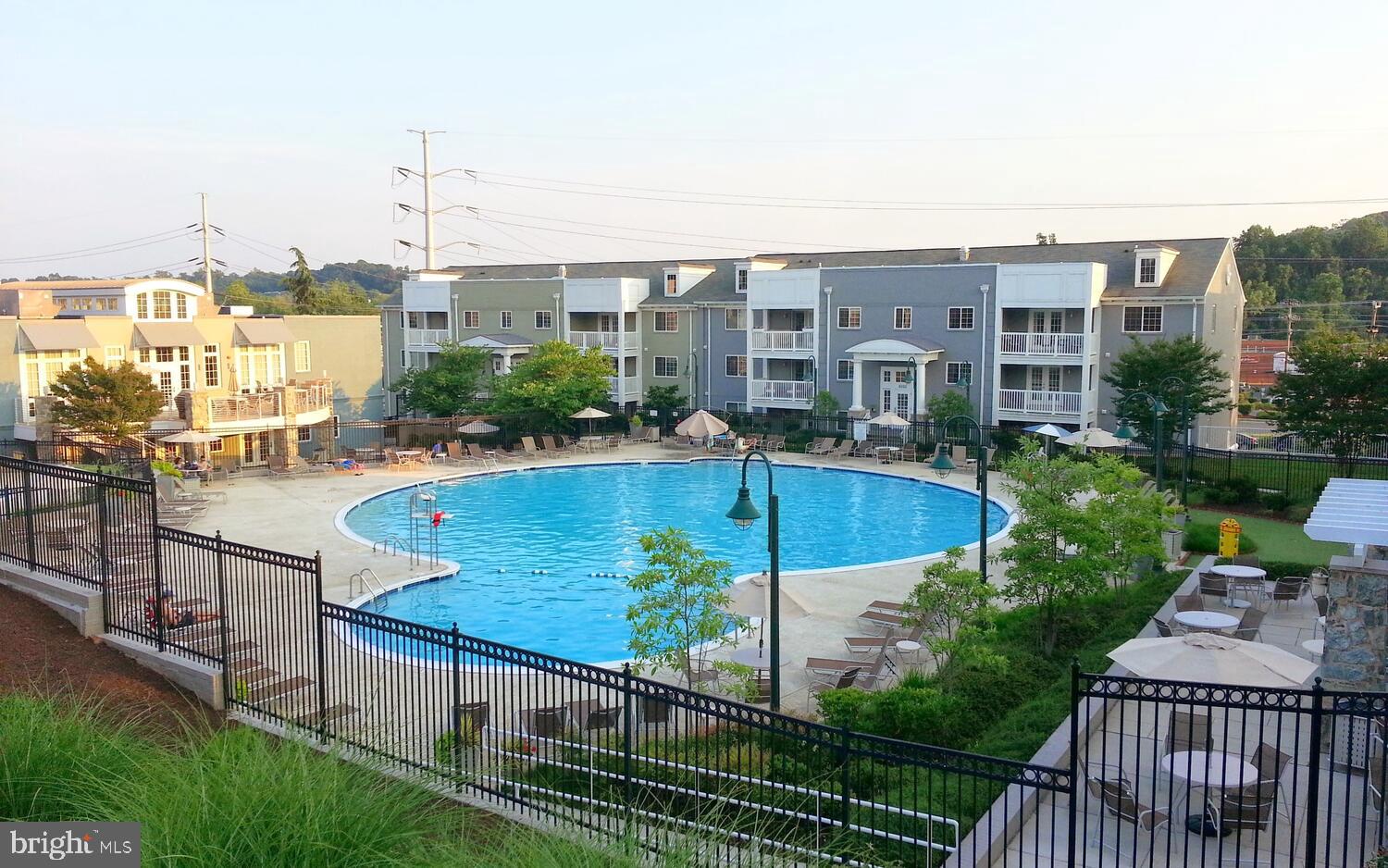 4113 South Four Mile Run Drive, Unit 404 Arlington, VA 22204 - Photo 29 of 39 a view of a swimming pool with a garden and patio