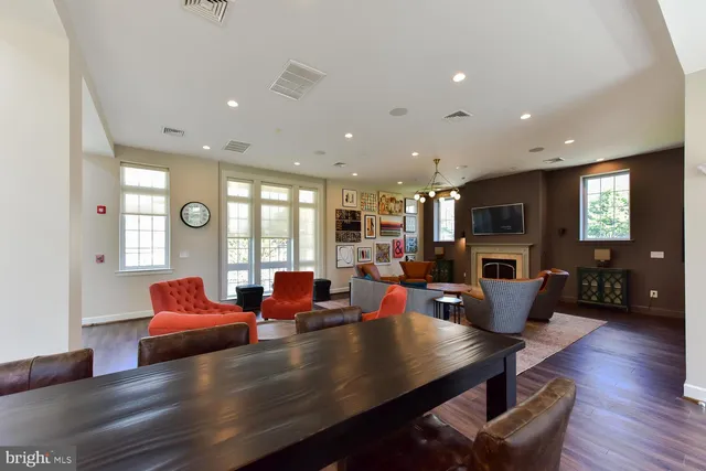 a view of a kitchen with furniture and wooden floor