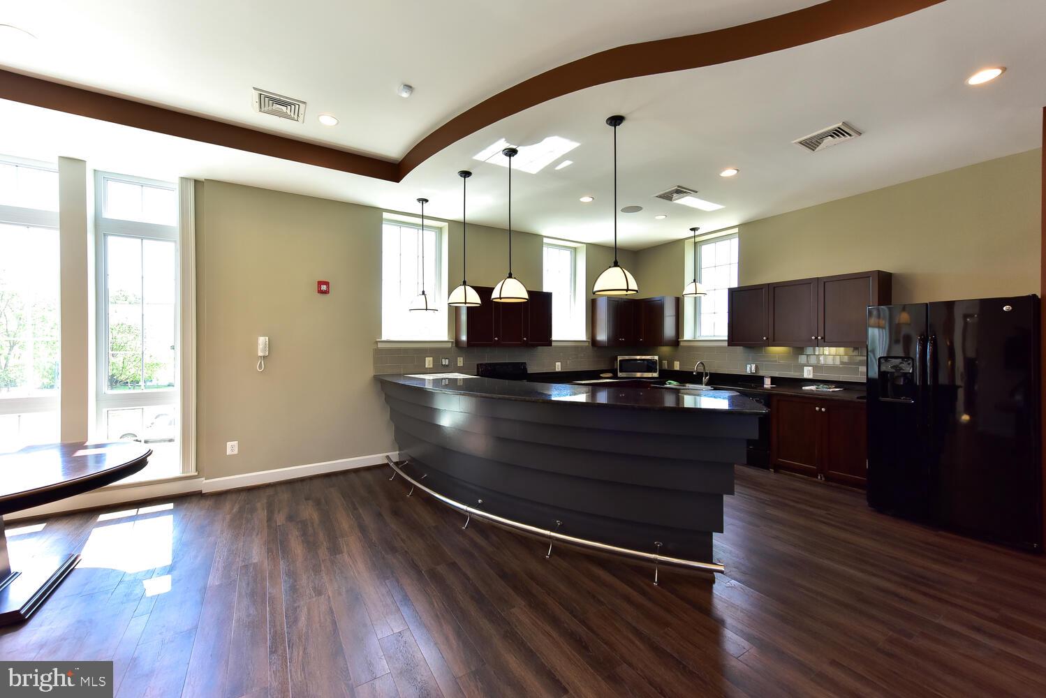 4113 South Four Mile Run Drive, Unit 404 Arlington, VA 22204 - Photo 32 of 39 a view of a kitchen with furniture and wooden floor