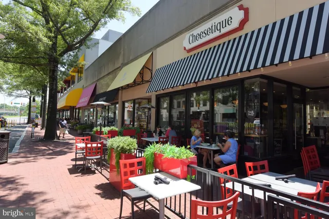 a view of street with retail shops