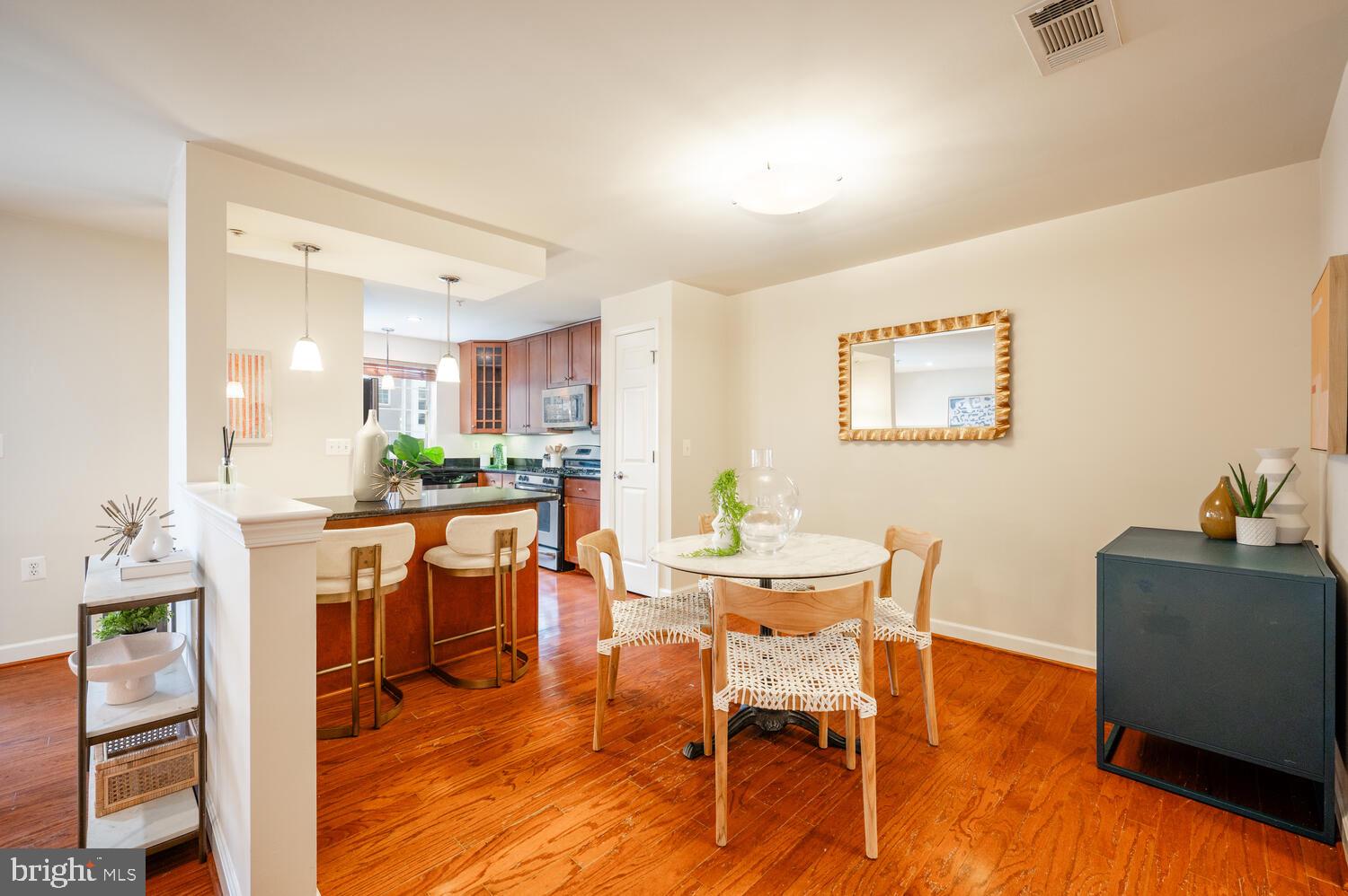 4113 South Four Mile Run Drive, Unit 404 Arlington, VA 22204 - Photo 5 of 39 a view of a dining room with furniture and wooden floor