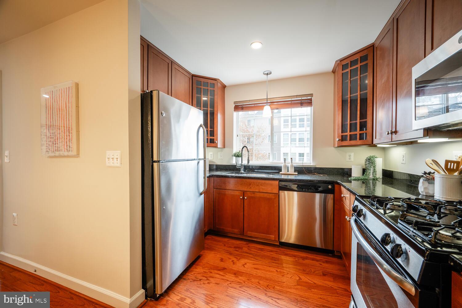 4113 South Four Mile Run Drive, Unit 404 Arlington, VA 22204 - Photo 8 of 39 a kitchen with stainless steel appliances granite countertop a refrigerator stove and sink