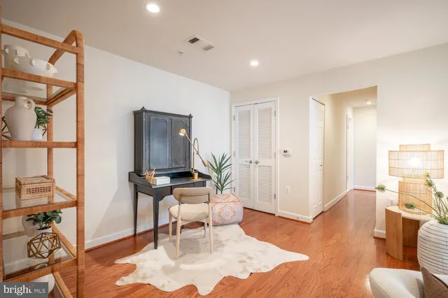 a living room with furniture a rug and white walls