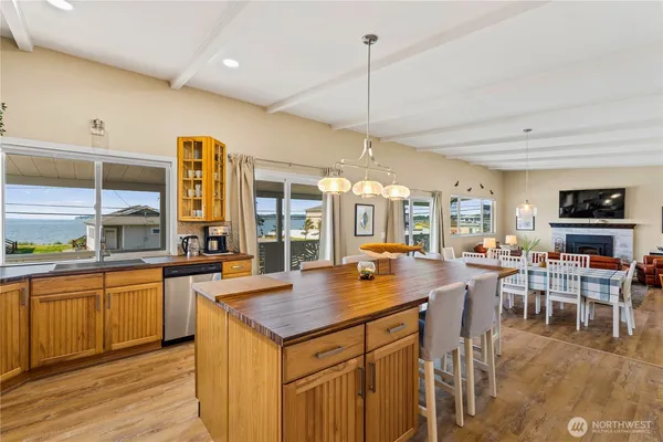 a kitchen with stainless steel appliances granite countertop a refrigerator a sink and a stove