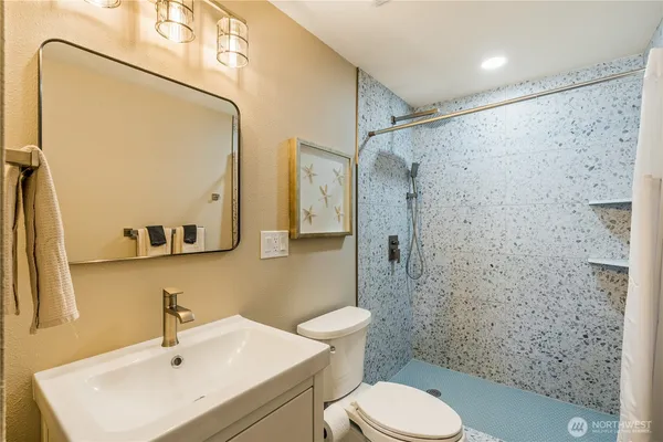 a kitchen with stainless steel appliances granite countertop a refrigerator a stove top oven a sink and dishwasher