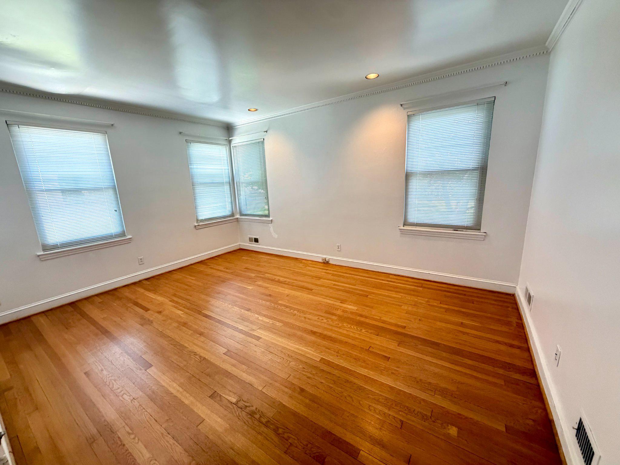6318 Winner Avenue Baltimore, MD 21215 - Photo 33 of 75 an empty room with wooden floor and windows
