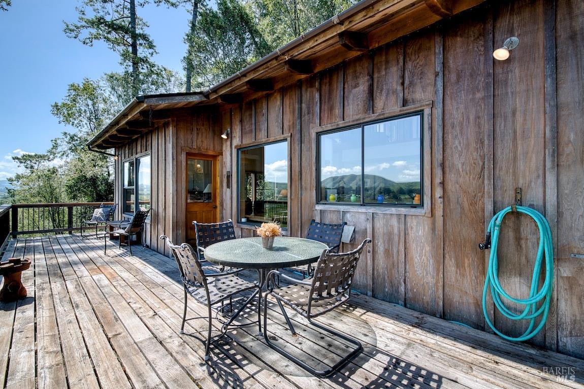 57 Laurel Street Inverness, CA 94956 - Photo 19 of 45 a backyard of a house with barbeque oven table and chairs