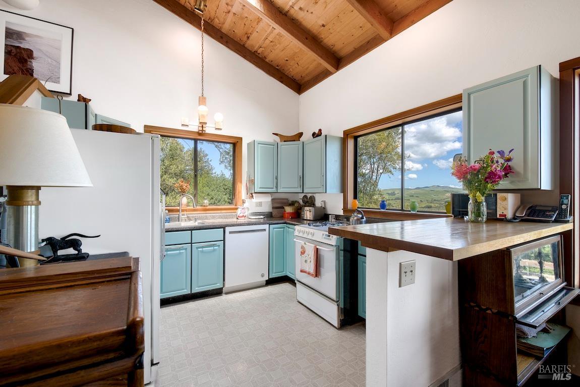 57 Laurel Street Inverness, CA 94956 - Photo 20 of 45 a kitchen with a sink stove and cabinets