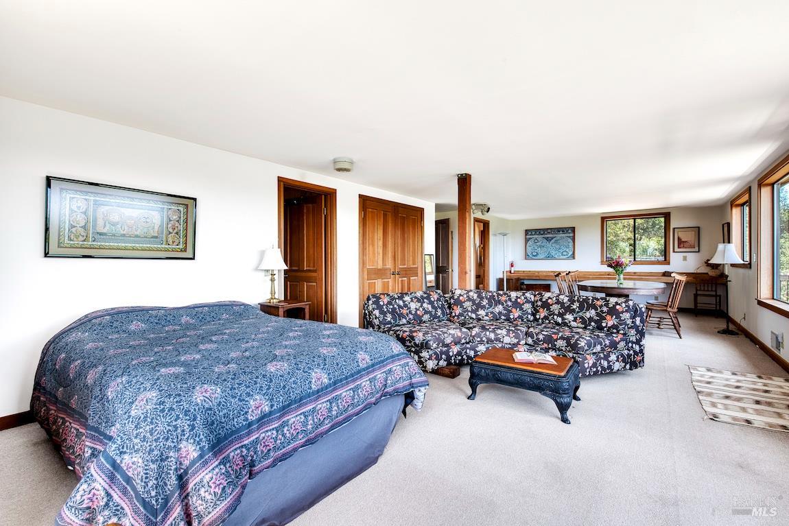 57 Laurel Street Inverness, CA 94956 - Photo 31 of 45 a bedroom with bed couch and window