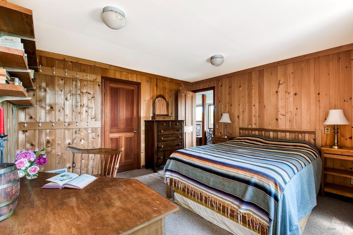 57 Laurel Street Inverness, CA 94956 - Photo 38 of 45 a bedroom with bed and wooden floor